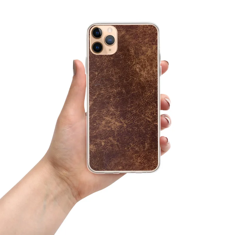 Worn Leather Vintage Clear Case for iPhone — distressed leather texture in deep mahogany and warm tan with crackled surface