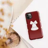 Glossy Jingle Bells Holiday Tough Case for iPhone — three white Christmas bells with ribbon bows arranged in a row on a deep
