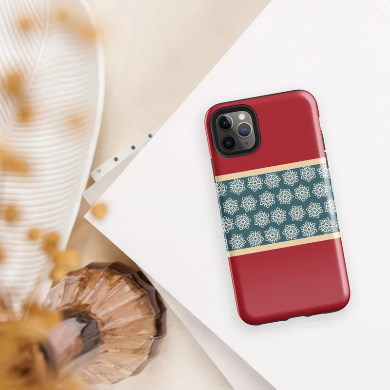 Glossy Crimson Snowflake Border Tough Case for iPhone — teal band of repeating geometric snowflake medallions in cream