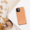 Glossy Warm Geometric Triangle Pattern Tough Case for iPhone — repeating pinwheel triangles in coral, golden yellow, peach