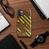 Glossy Rusted Hazard Zone Tough Case for iPhone — weathered rust-brown metal surface covered in diagonal yellow and black