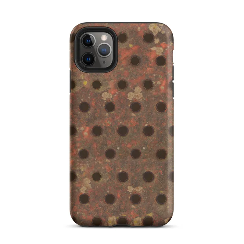 Matte Industrial Rust Perforated Metal Tough Case for iPhone — close-up of heavily rusted perforated steel plate with rows