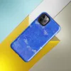 Glossy Electric Blue Splatter Storm Tough Case for iPhone — vivid cobalt blue textured surface covered in scattered white