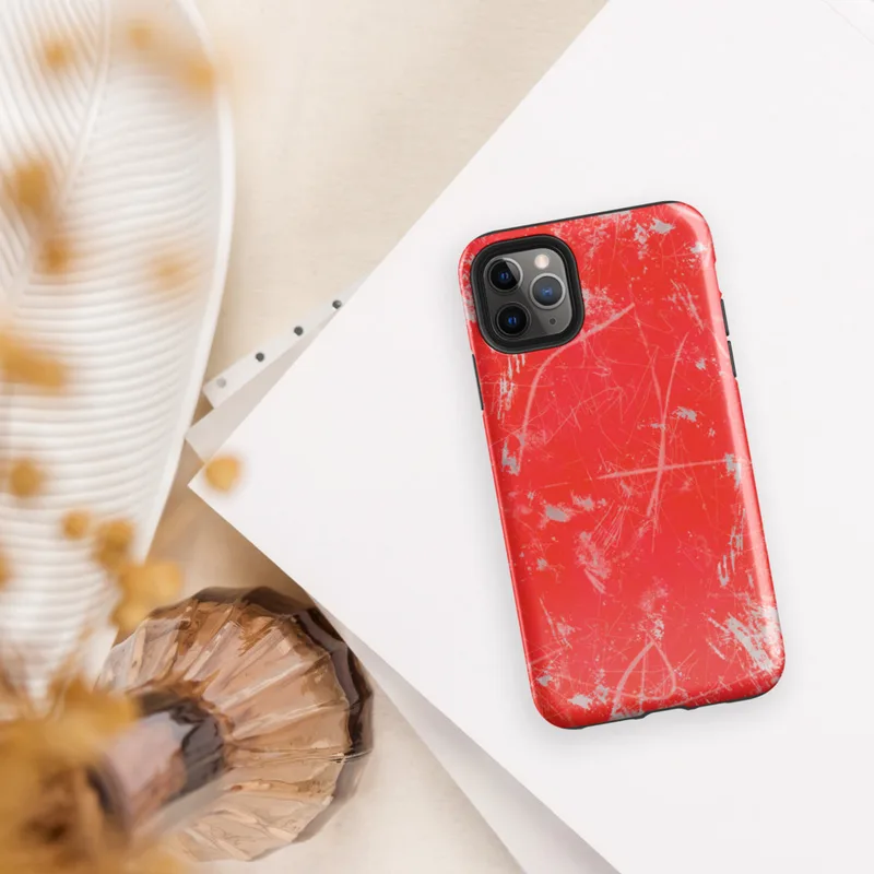 Glossy Red Chaos Splatter Tough Case for iPhone — explosive red background covered in silver-gray paint splatters, wild