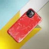 Glossy Red Chaos Splatter Tough Case for iPhone — explosive red background covered in silver-gray paint splatters, wild