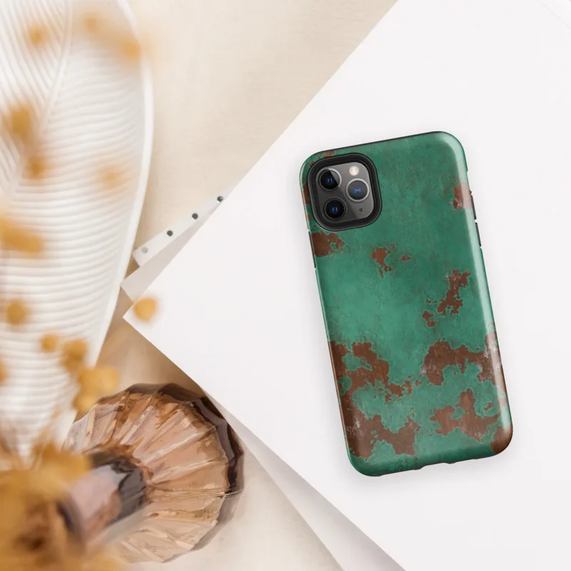 Glossy Copper Patina Storm Tough Case for iPhone — seamless oxidized copper surface with teal-green verdigris patina