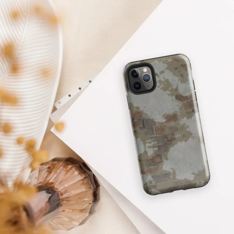 Glossy Urban Decay Exposed Brick Tough Case for iPhone — weathered wall with peeling white plaster revealing rusty brown