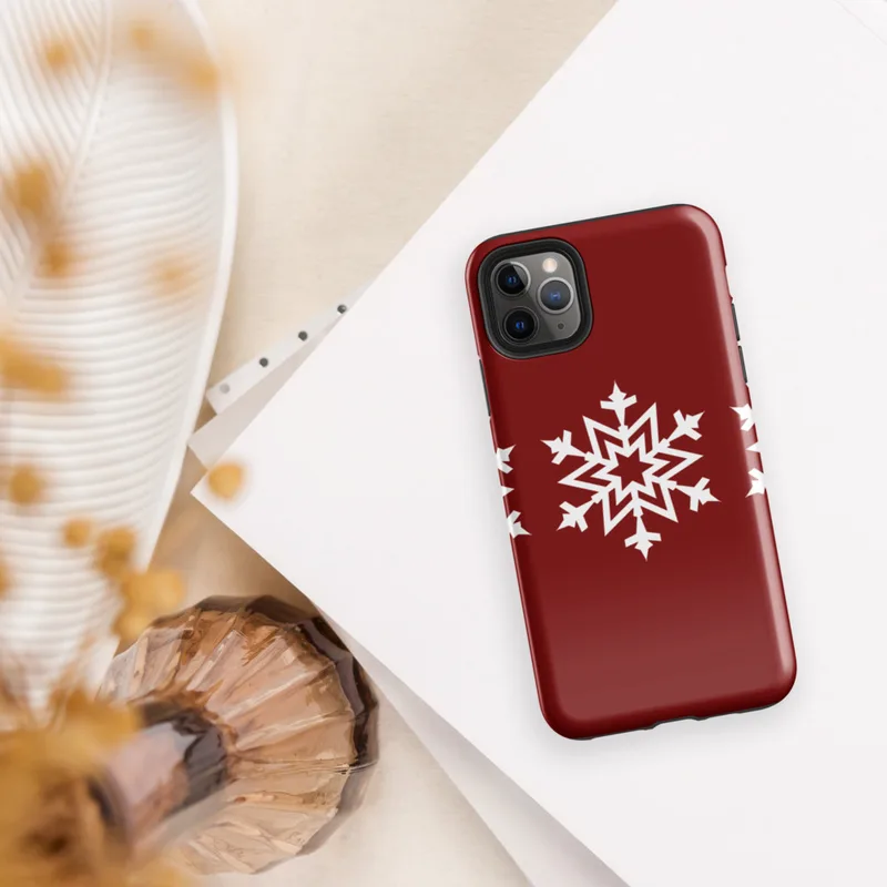 Glossy Winter Snowflake Trio Tough Case for iPhone — three identical white geometric snowflakes arranged in a row on a deep