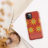 Glossy Solar Bloom Red Tough Case for iPhone — repeating pattern of yellow sunburst flowers with blue centers on a vivid red