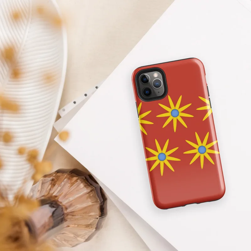 Glossy Solar Bloom Red Tough Case for iPhone — repeating pattern of yellow sunburst flowers with blue centers on a vivid red