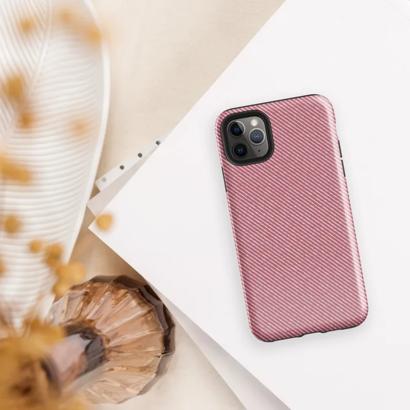diagonal white pinstripes on a warm muted red background mimicking a woven twill fabric texture on Glossy Classic Red Diagonal Twill Tough Case for iPhone - default view