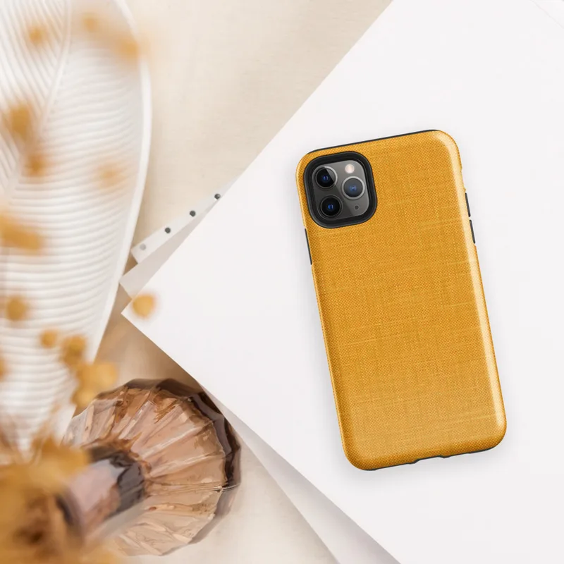close-up woven linen fabric texture in warm golden amber and saffron tones with subtle thread detail on Glossy Golden Linen Texture Tough Case for iPhone - default view