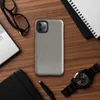 micro-checkerboard pattern in slate gray and warm sand with subtle colorful flecks and fine thread-like lines suggesting woven fabric on Glossy Steel Grid Woven Texture Tough Case for iPhone - default view