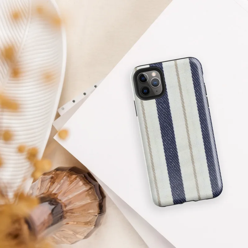 vertical ticking stripe pattern with wide navy blue bands, crisp white panels, and narrow taupe pinstripe accents on woven textile texture on Glossy Coastal Ticking Stripe Classic Tough Case for iPhone - default view