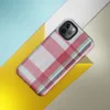 traditional tartan plaid pattern with bold red, navy, forest green, and white intersecting woven stripes on Glossy Classic Plaid Heritage Tough Case for iPhone - default view
