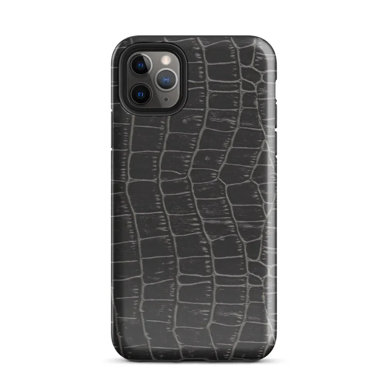 close-up black crocodile scale skin texture with raised interlocking rectangular scales and deep charcoal tones on Glossy Midnight Crocodile Armor Tough Case for iPhone - default view
