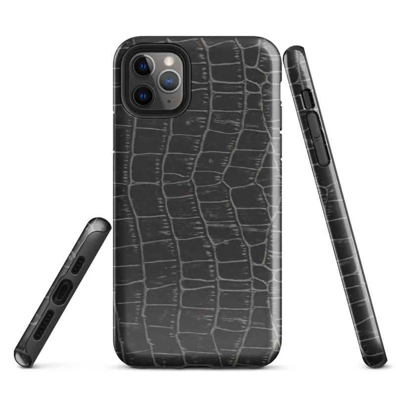 close-up black crocodile scale skin texture with raised interlocking rectangular scales and deep charcoal tones on Glossy Midnight Crocodile Armor Tough Case for iPhone - default view
