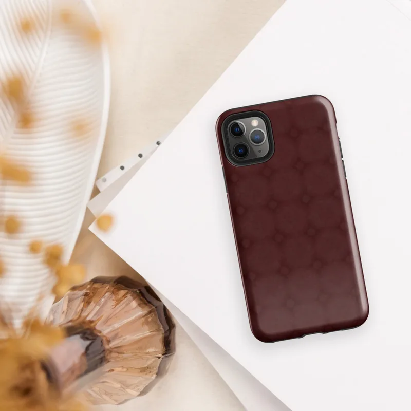 tone-on-tone deep crimson repeating lattice of interlocking circles and diamond accents with a soft textured burgundy background on Glossy Crimson Lattice Elegance Tough Case for iPhone - default view