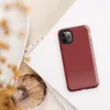 flat solid deep crimson red with no pattern or imagery, rich muted scarlet tone filling the entire surface on Glossy Crimson Red Solid Bold Tough Case for iPhone - default view