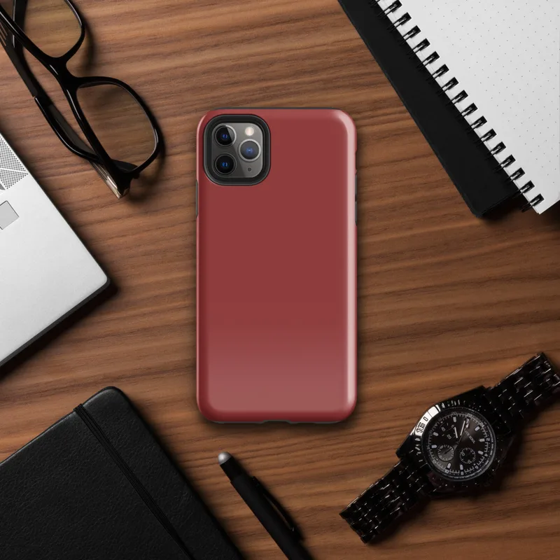 flat solid deep crimson red with no pattern or imagery, rich muted scarlet tone filling the entire surface on Glossy Crimson Red Solid Bold Tough Case for iPhone - default view