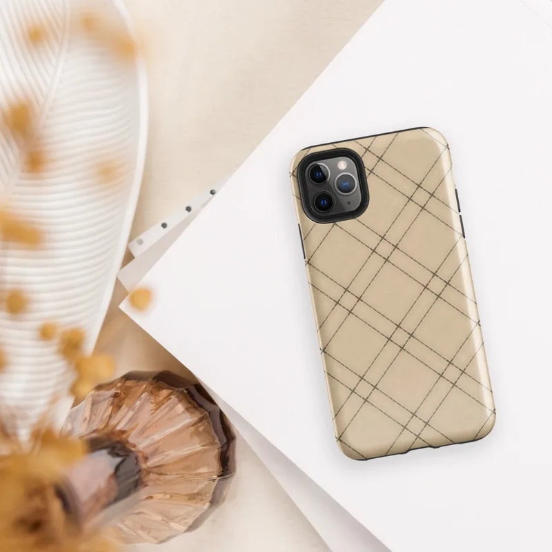 diagonal plaid grid of double dark brown lines forming diamond shapes on a warm beige and tan textured background on Glossy Classic Diagonal Plaid Tough Case for iPhone - default view