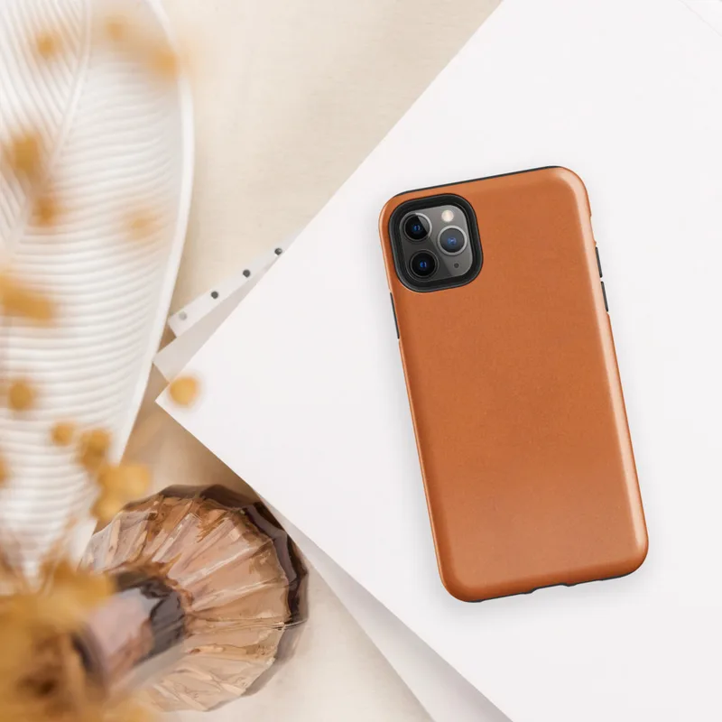 solid flat burnt orange in a warm earthy tone with subtle texture variation across the surface on Glossy Burnt Orange Solid Classic Tough Case for iPhone - default view