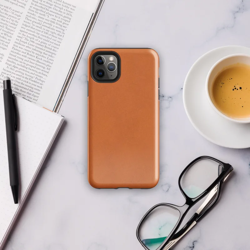 solid flat burnt orange in a warm earthy tone with subtle texture variation across the surface on Glossy Burnt Orange Solid Classic Tough Case for iPhone - default view