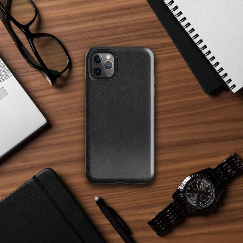 Glossy Scratched Black Leather Tough Case for iPhone — close-up black leather surface with fine grain pores and scattered