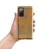 torn and peeling kraft paper revealing corrugated cardboard fluting beneath, warm amber and taupe tones with ragged irregular edges on Glossy Worn Cardboard World Tough Case for Samsung - default - Front view