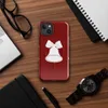 Glossy Jingle Bells Trio Holiday MagSafe Tough Case for iPhone — three white illustrated bells with ribbon bows arranged