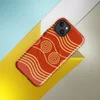 Glossy Ancient Waves Gold Spiral MagSafe Tough Case for iPhone — repeating golden spiral circles and wavy parallel lines