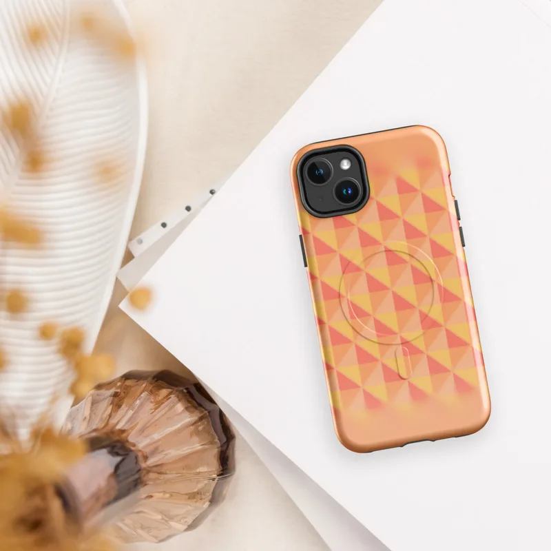 Glossy Sunset Grid Geometric MagSafe Tough Case for iPhone — repeating triangle grid mosaic in warm coral, peach, blush