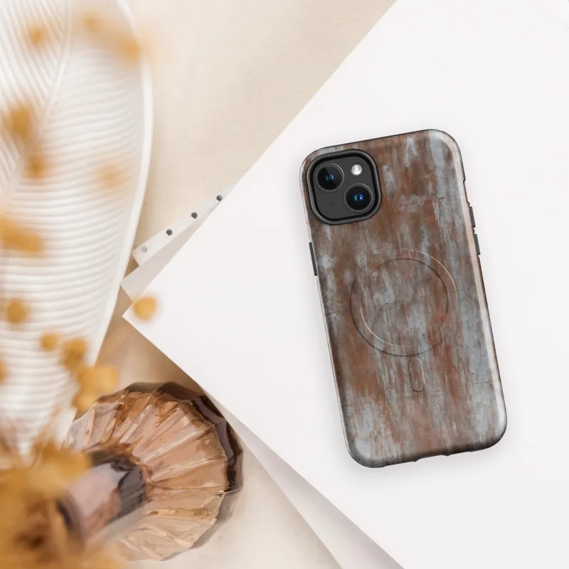 Glossy Rusted Iron Fortress MagSafe Tough Case for iPhone — heavily weathered metal panels with streaking rust in burnt