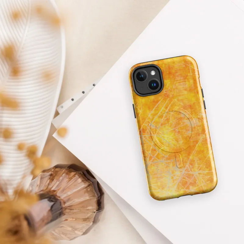 Glossy Solar Flare Scratch MagSafe Tough Case for iPhone — mottled orange and golden yellow surface overlaid with scattered