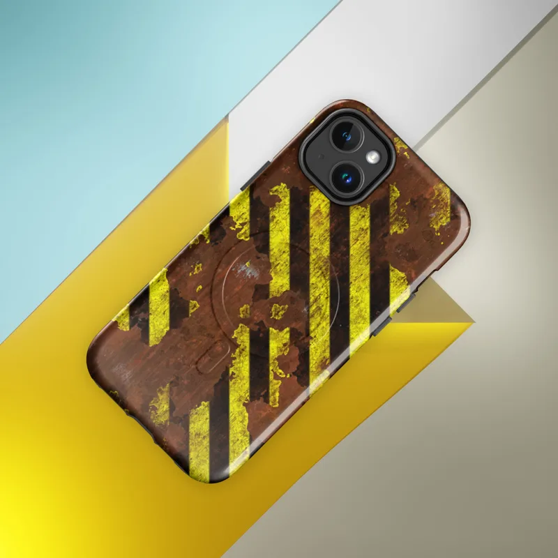 Glossy Hazard Zone Rusted Steel MagSafe Tough Case for iPhone — diagonal yellow and black hazard stripes over a heavily