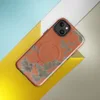 Glossy Crumbling Walls Rust MagSafe Tough Case for iPhone — peeling terracotta orange plaster revealing muted sage and stone