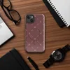 Glossy Crimson Cross Stitch MagSafe Tough Case for iPhone — repeating white cross-stitch X marks and diagonal line stitches