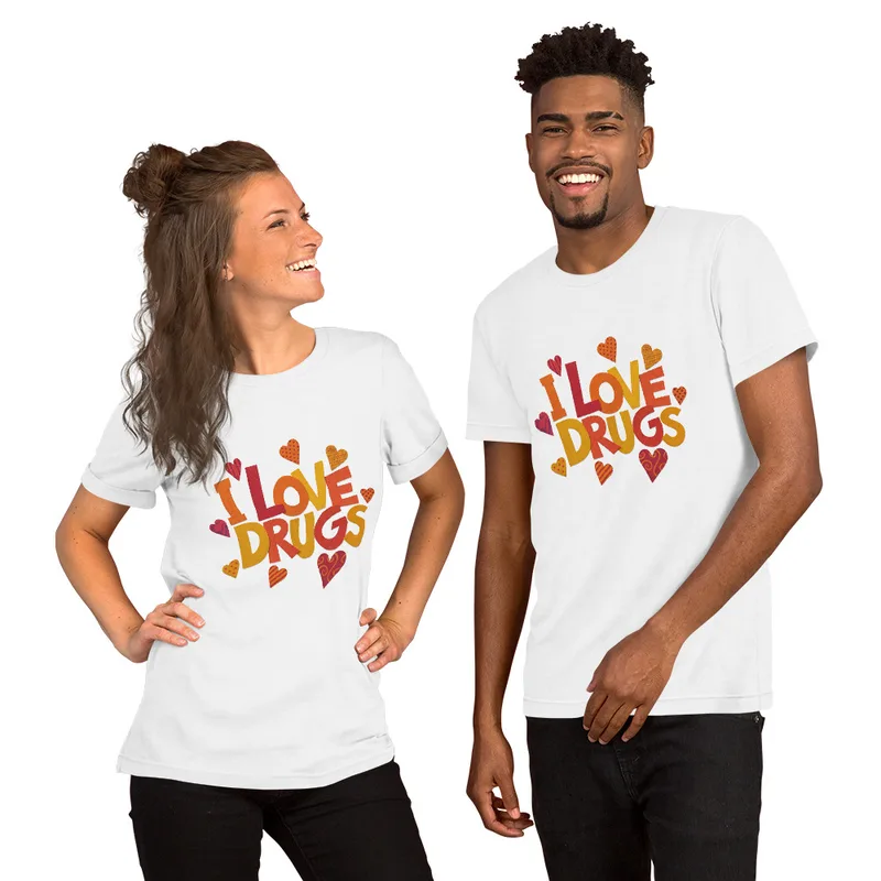 White I Love Drugs Bold Statement Tee — bold chunky lettering reading I Love Drugs in warm orange red and yellow tones
